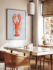 Red lobster illustration with large claws on a light blue and white striped background, in a styled room mockup