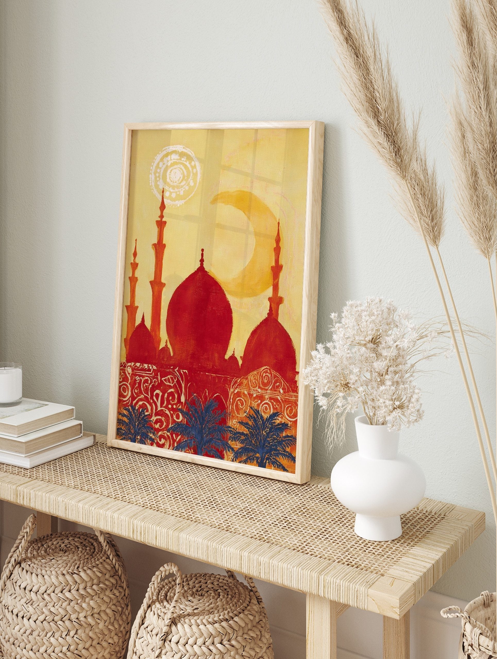 Red mosque silhouette with domes and minarets against a yellow sky, blue palm trees, and a, in an alternate framed mockup