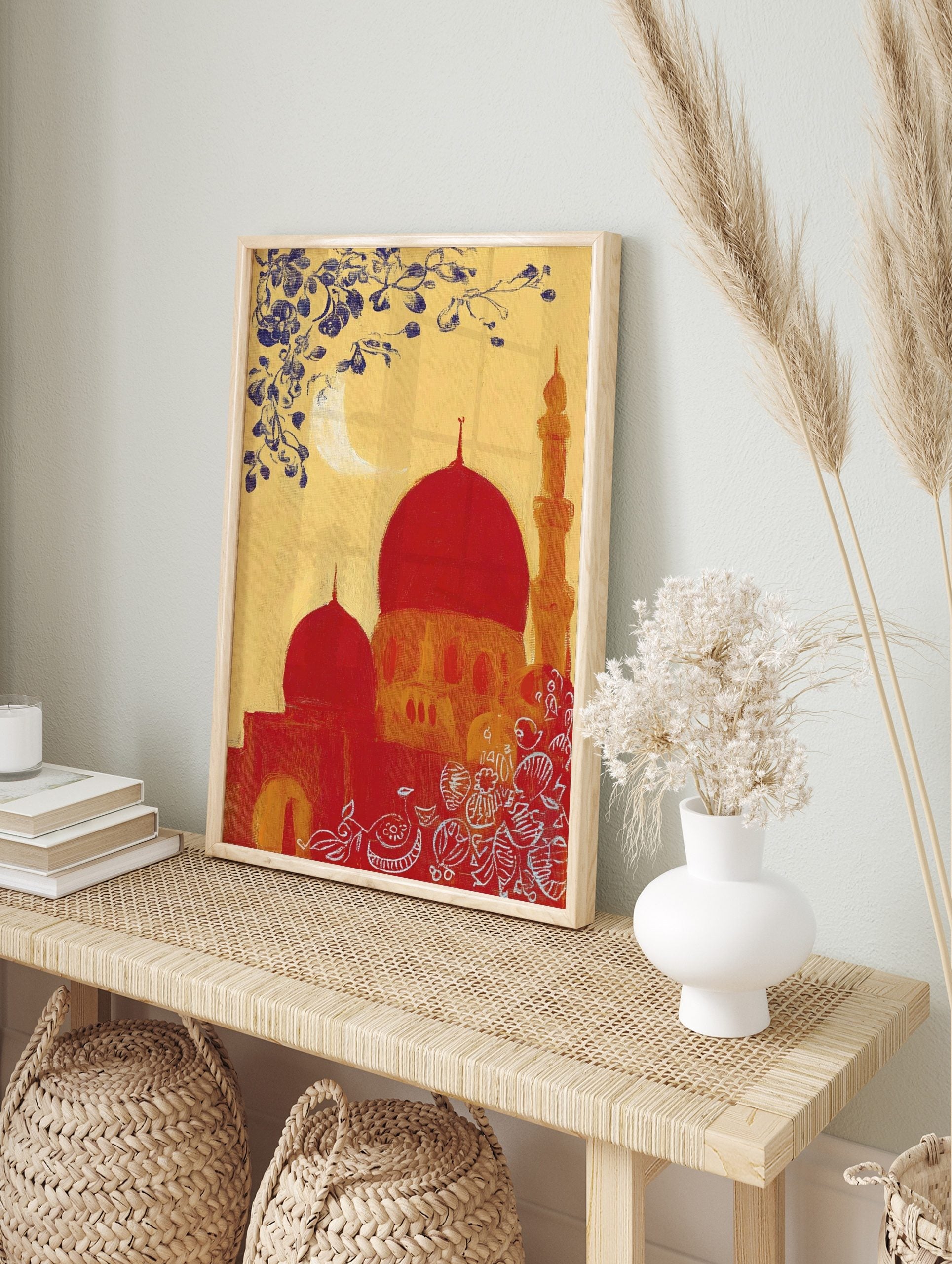 Red mosque with golden minaret under a crescent moon and blue floral branch on a yellow, in an alternate framed mockup