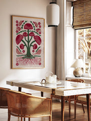 Illustrative red mushroom folk art print with green stems, red caps, and intricate roots on a light, in a styled room mockup