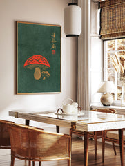Red mushroom illustration with gold Japanese calligraphy on a dark green background, woodblock, in a styled room mockup