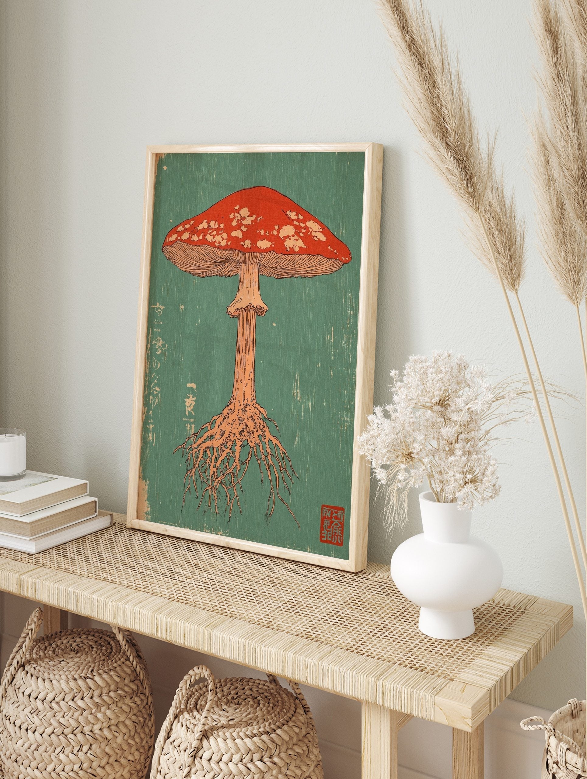 Red mushroom illustration with white spots, gills, and roots on a teal background in Japanese, in an alternate framed mockup
