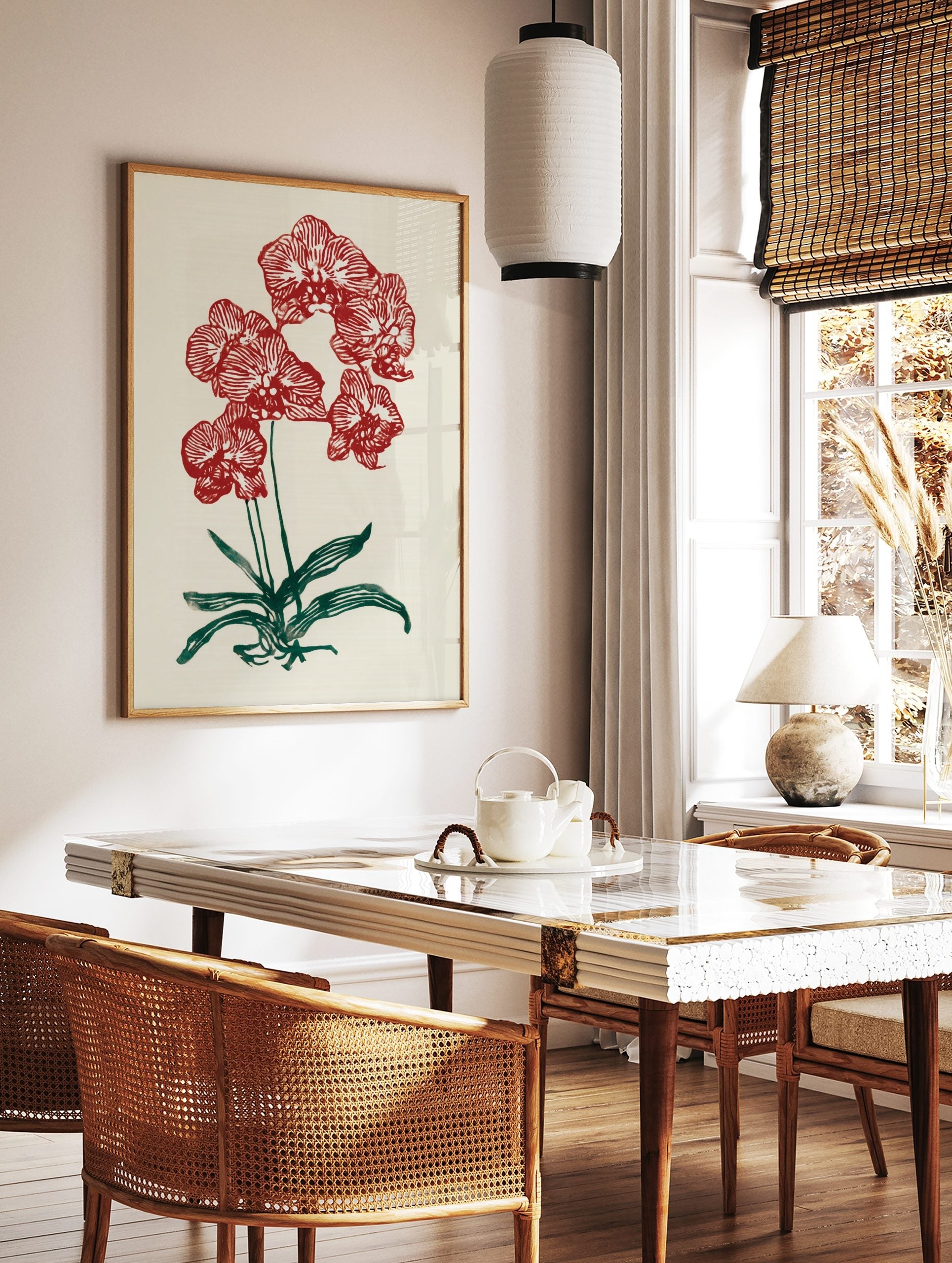 Red orchid botanical illustration wall art print with green leaves on a cream background, in a styled room mockup