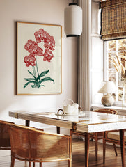 Red orchid botanical illustration wall art print with green leaves on a cream background, in a styled room mockup