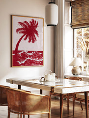 Red palm tree and ocean waves art print in an illustrative, high-contrast two-tone style, in a styled room mockup