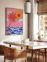 Red palm tree and golden sun over stylised blue ocean waves against a pink sky, illustrative art, in a styled room mockup