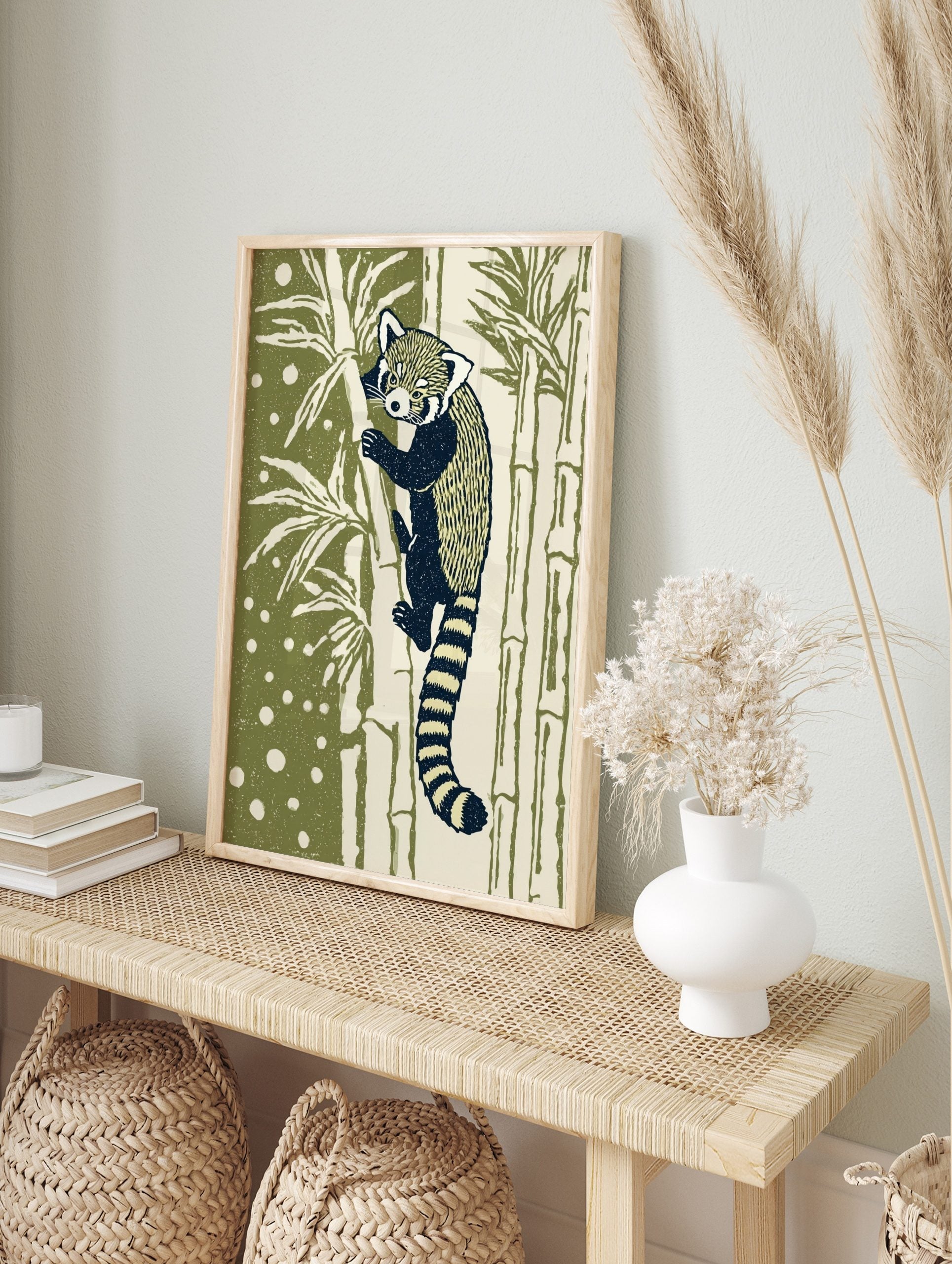 Illustrative red panda climbing bamboo art print with dark navy and cream fur, olive green, in an alternate framed mockup