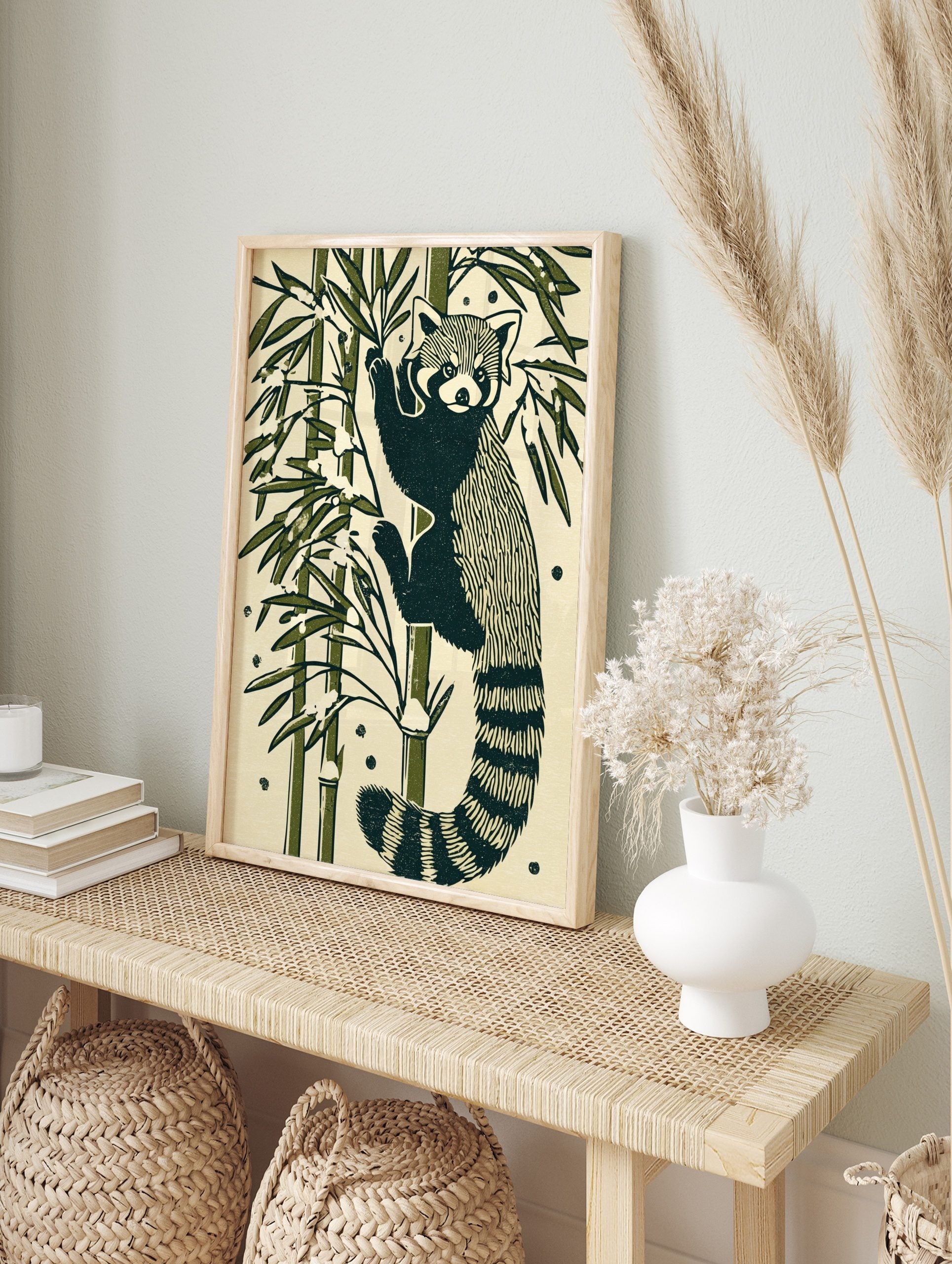 Illustrative red panda climbing bamboo stalk with green leaves and snow on a cream, in an alternate framed mockup