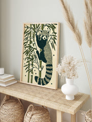 Illustrative red panda climbing bamboo stalk with green leaves and snow on a cream, in an alternate framed mockup