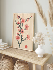 Red and pink plum blossom branch illustration with buds, dark grey stem, and a red circular, in an alternate framed mockup