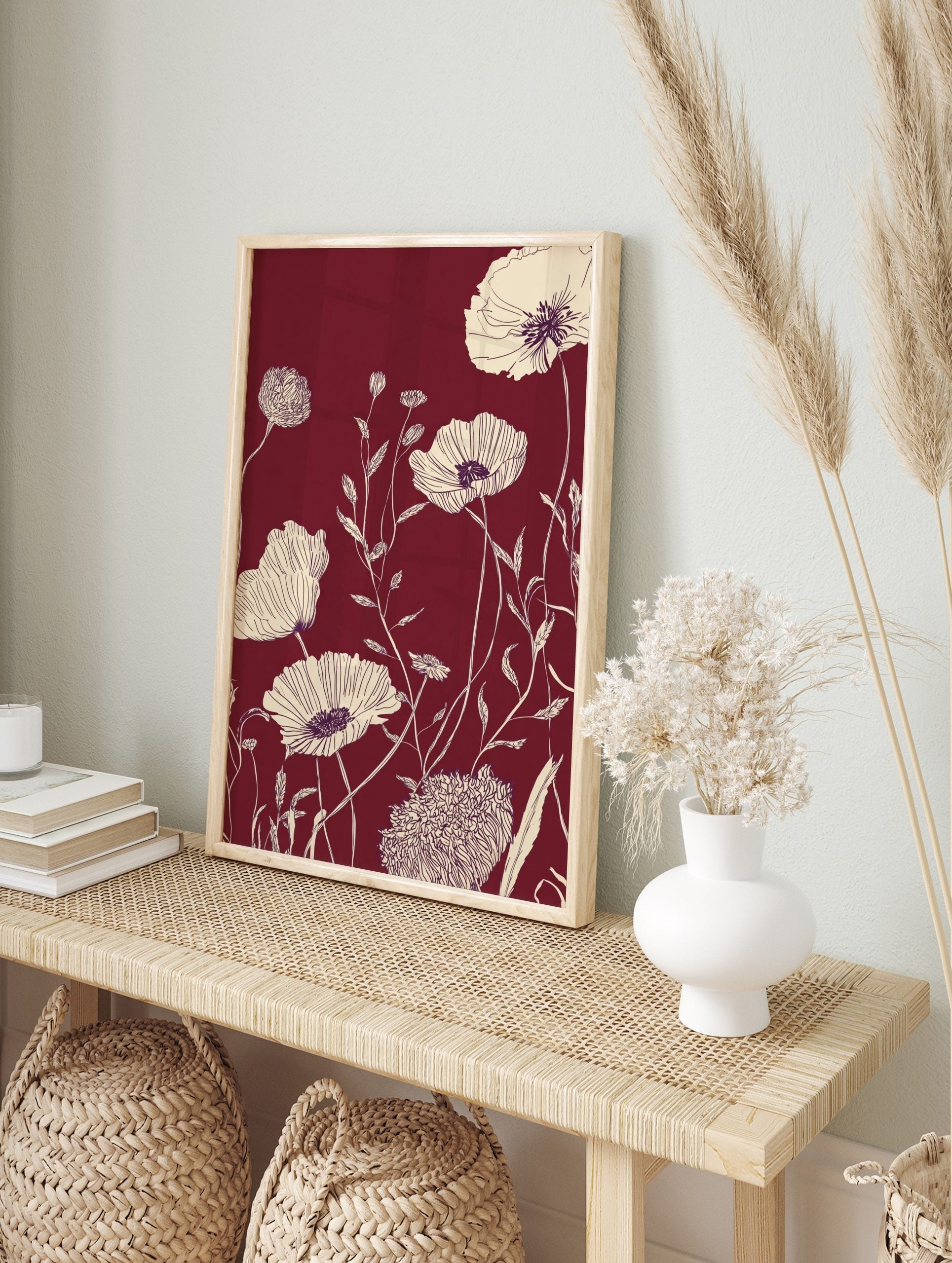 Cream line art poppy flowers and foliage on a deep maroon background in a botanical, in an alternate framed mockup