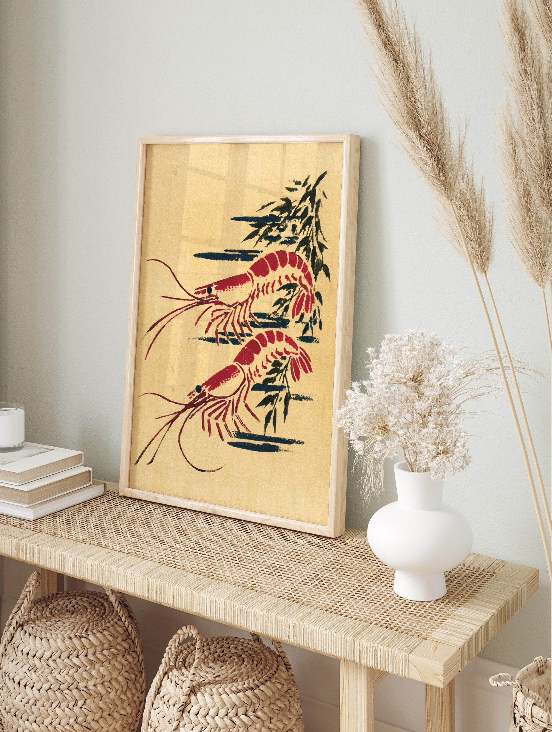 Red prawn wall art print with two illustrative shrimp and dark abstract shapes on a beige, in an alternate framed mockup