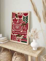 Stylised red record player wall art with botanical flowers and hands in a vibrant folk art, in an alternate framed mockup