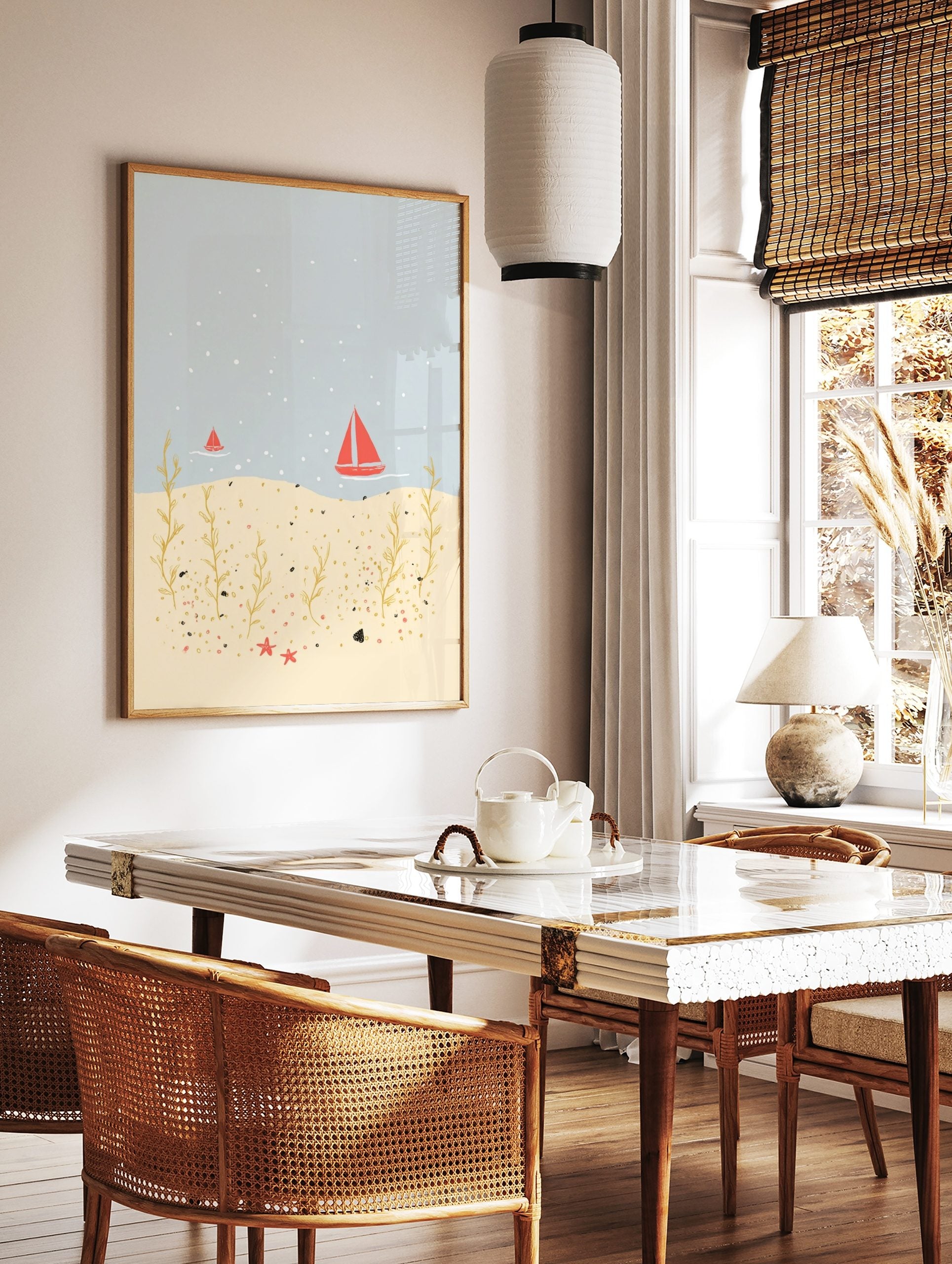 Illustrative coastal scene with red sailboats on blue water, golden seaweed, and red starfish on a, in a styled room mockup