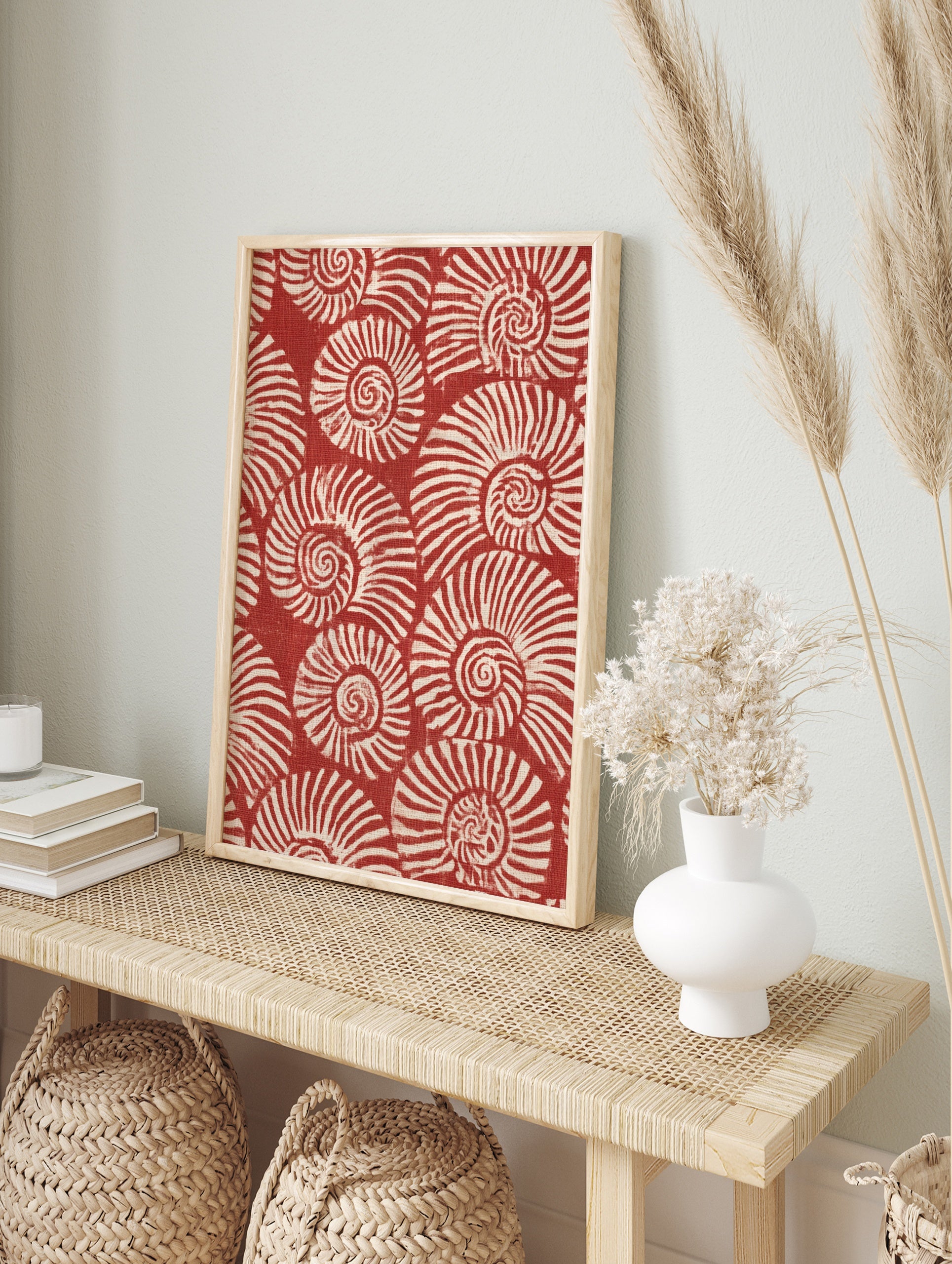 Repeating pattern of white spiralling nautilus shells on a deep red background, illustrative, in an alternate framed mockup