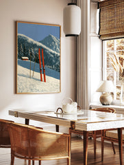 Red skis and poles in deep snow with a mountain cabin and forest background illustration, in a styled room mockup