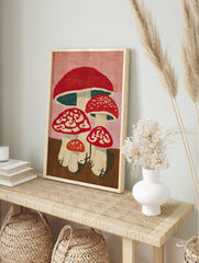 Illustrative red spotted mushroom wall art with white stems and pink background