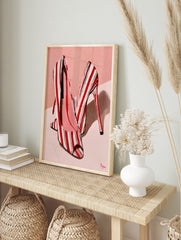 Fashion illustration of red and white striped high heel shoes on a soft pink background, in an alternate framed mockup