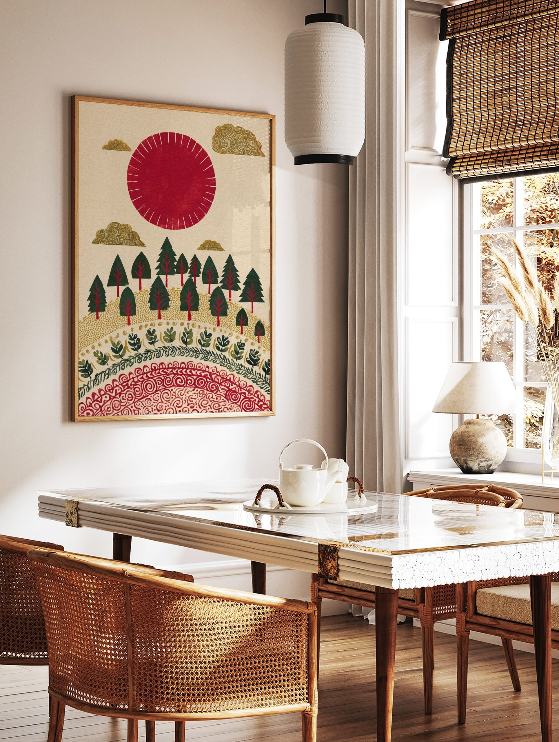 Illustrative red sun and golden clouds over a green forest with decorative patterns on a cream, in a styled room mockup