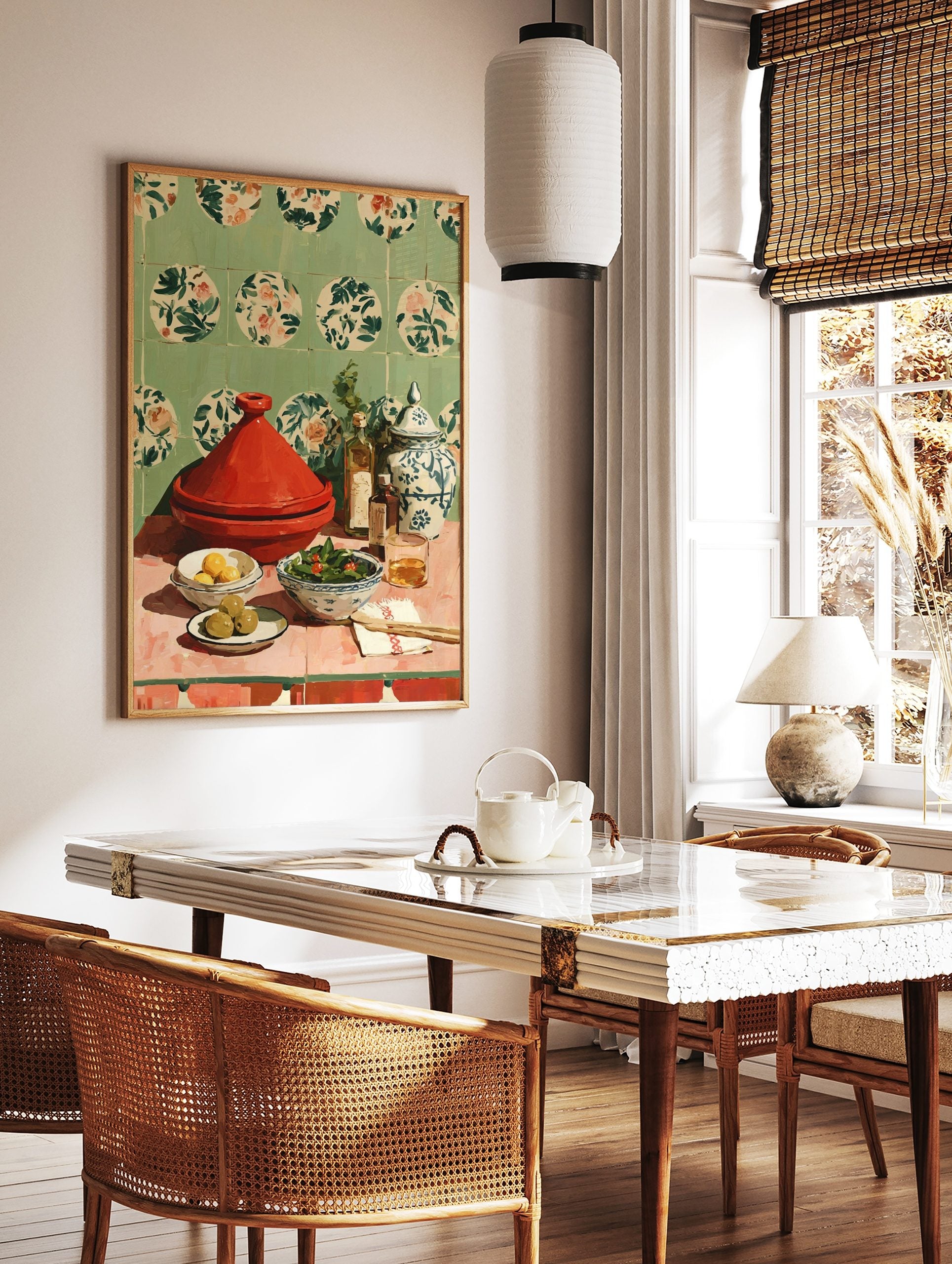 Red tagine pot, lemons, olives, salad, oil bottles, and patterned jar on pink table with green, in a styled room mockup