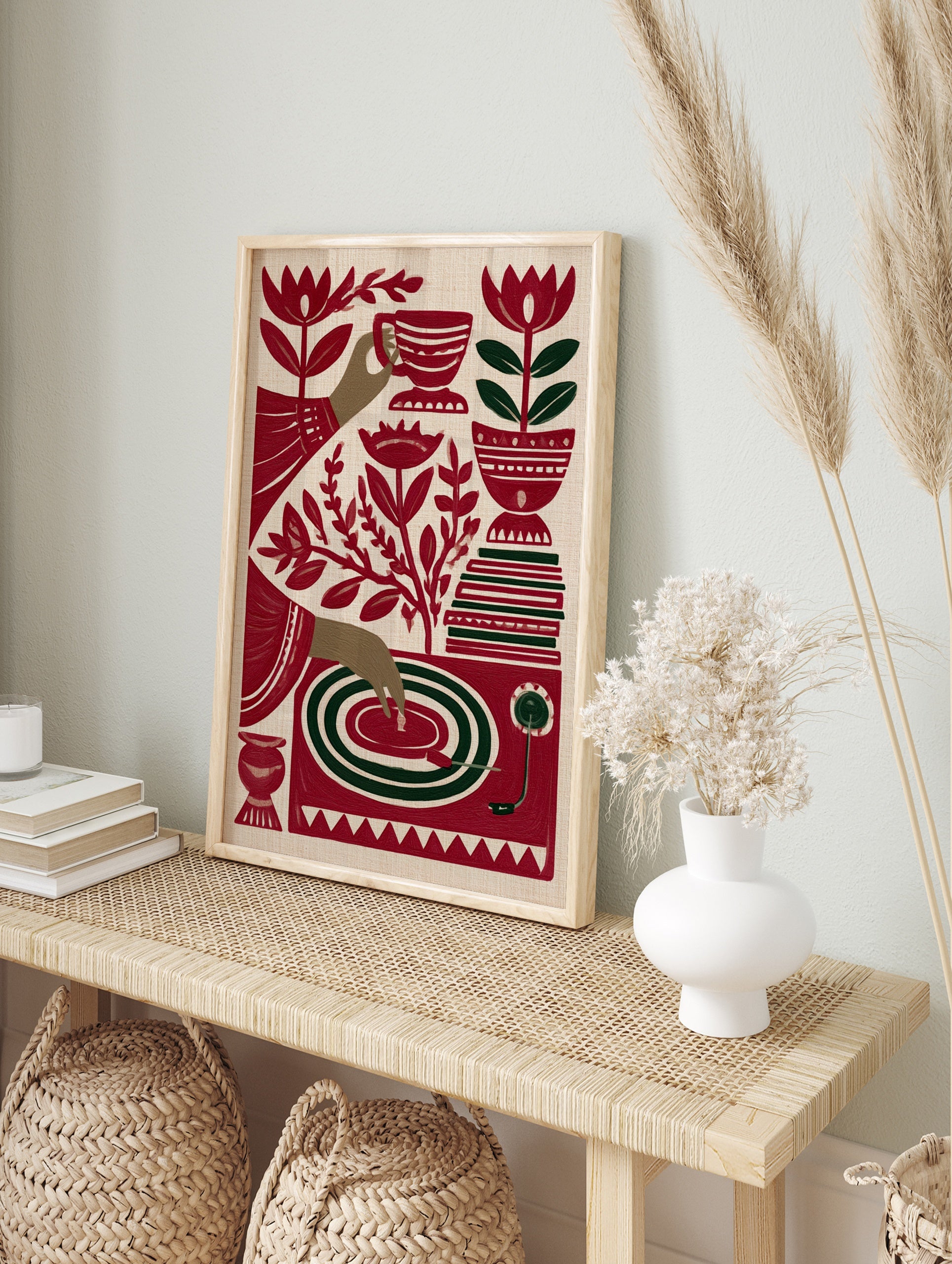 Stylized red and green illustrative art print of a tea cup, hand, record player, and flowers, in an alternate framed mockup