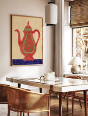Red teapot wall art with green ornate patterns and a blue decorative base on a beige background, in a styled room mockup