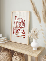 Red illustrative print of a tiger, sake bottle with Japanese text, and a turntable on a cream, in an alternate framed mockup