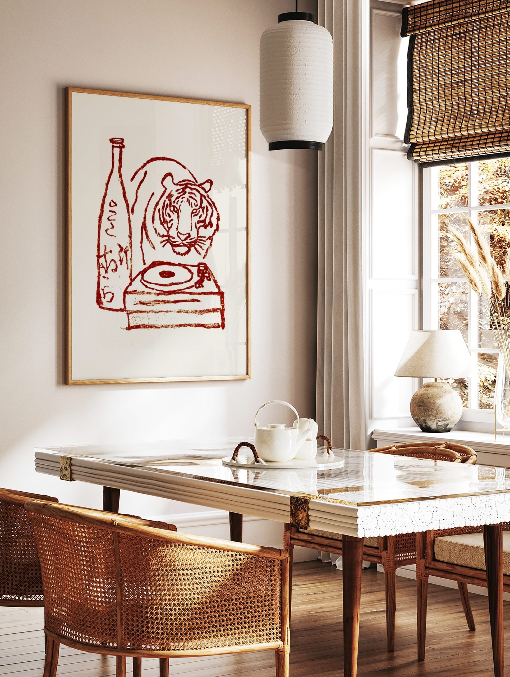 Red illustrative print of a tiger, sake bottle with Japanese text, and a turntable on a cream, in a styled room mockup