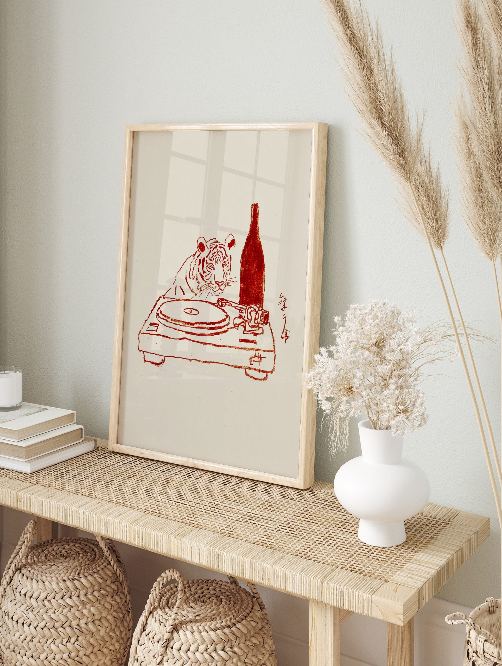 Red line art illustration of a tiger looking at a turntable with a bottle and Japanese, in an alternate framed mockup