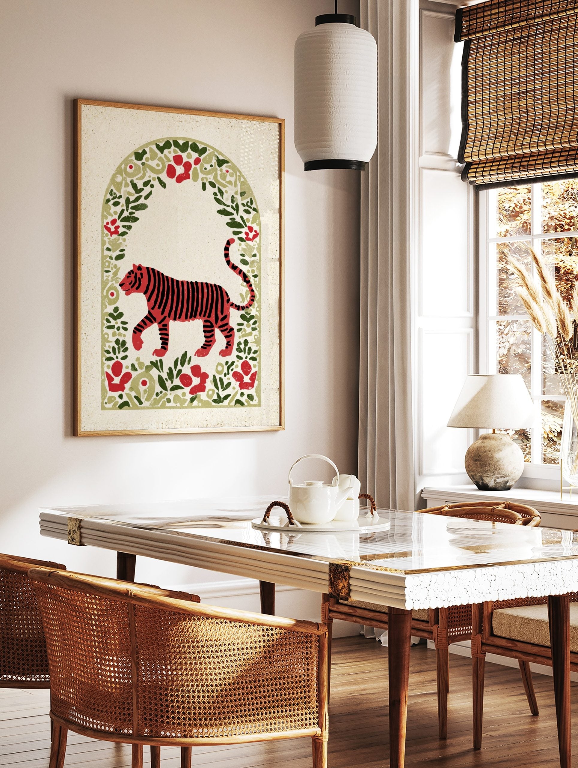 Red tiger illustration with black stripes, walking in an arched frame of green leaves and red, in a styled room mockup