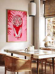 Red and white illustrative tiger walking forward, framed by red tropical leaves on a pink background, in a styled room mockup