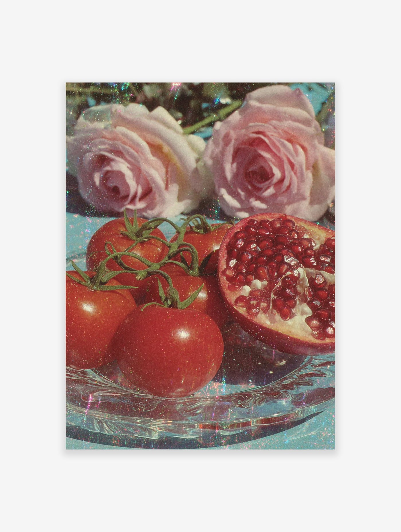 Poster of glistening red tomatoes, pink roses, and a sliced pomegranate on a clear glass plate with a blue background and glitter.
