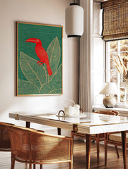 Red toucan bird with long beak perched on large tropical leaves on a green background, illustrative, in a styled room mockup