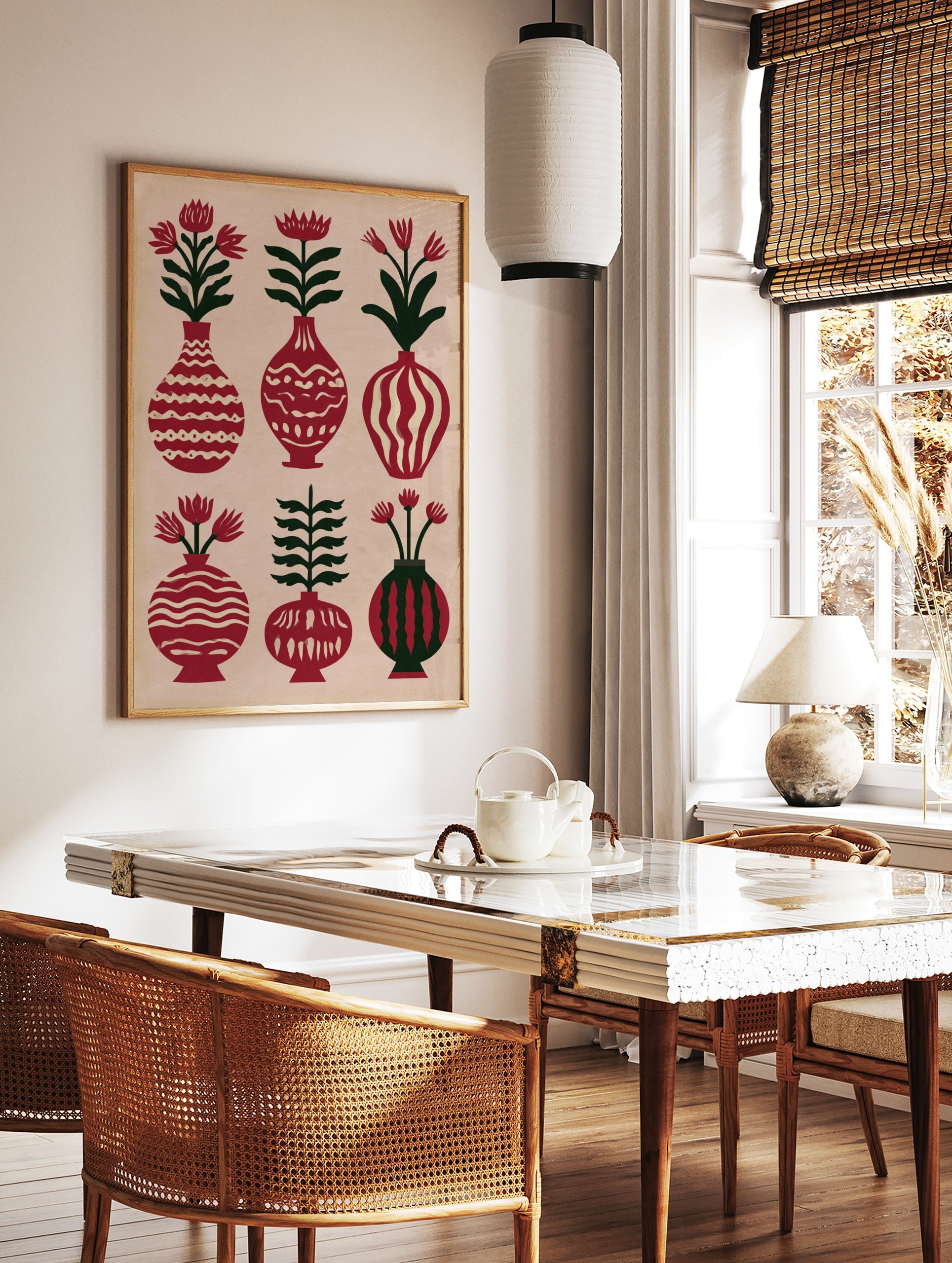 A folk art botanical poster showing six vases with flowers and leaves in red and green on a cream, in a styled room mockup