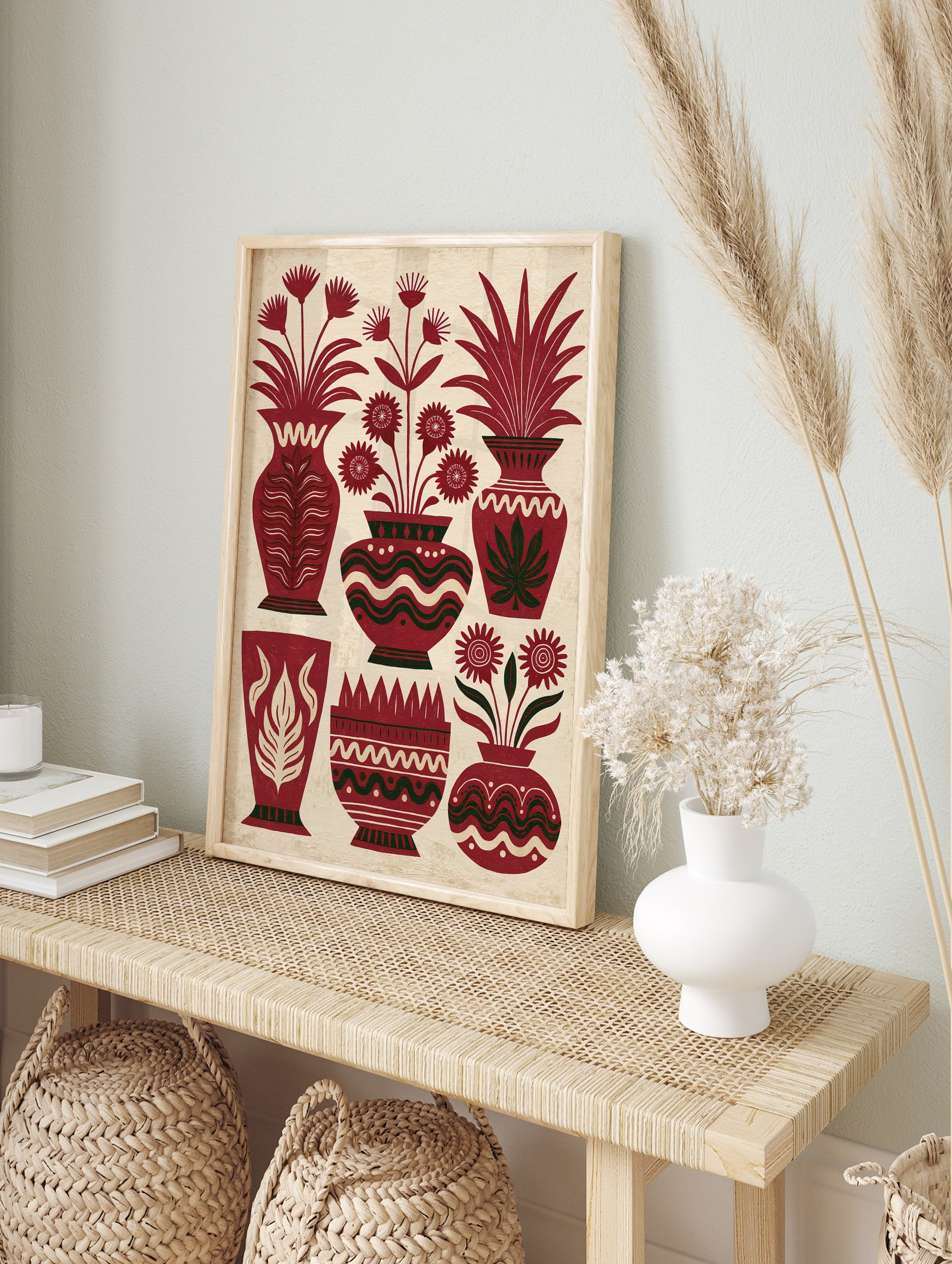 Illustrative red vase wall art with stylized flowers and leafy plants on a textured cream, in an alternate framed mockup