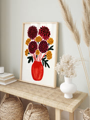 Illustrated red vase with dahlias and yellow flowers on a white background, in an alternate framed mockup