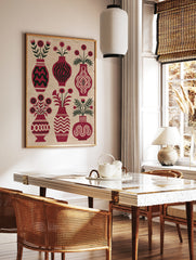 Botanical red vase wall art print with six floral arrangements and dark green foliage on a cream, in a styled room mockup