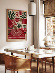 Illustrative red wall art print featuring a turntable, coffee cup, and potted plants on a neutral, in a styled room mockup