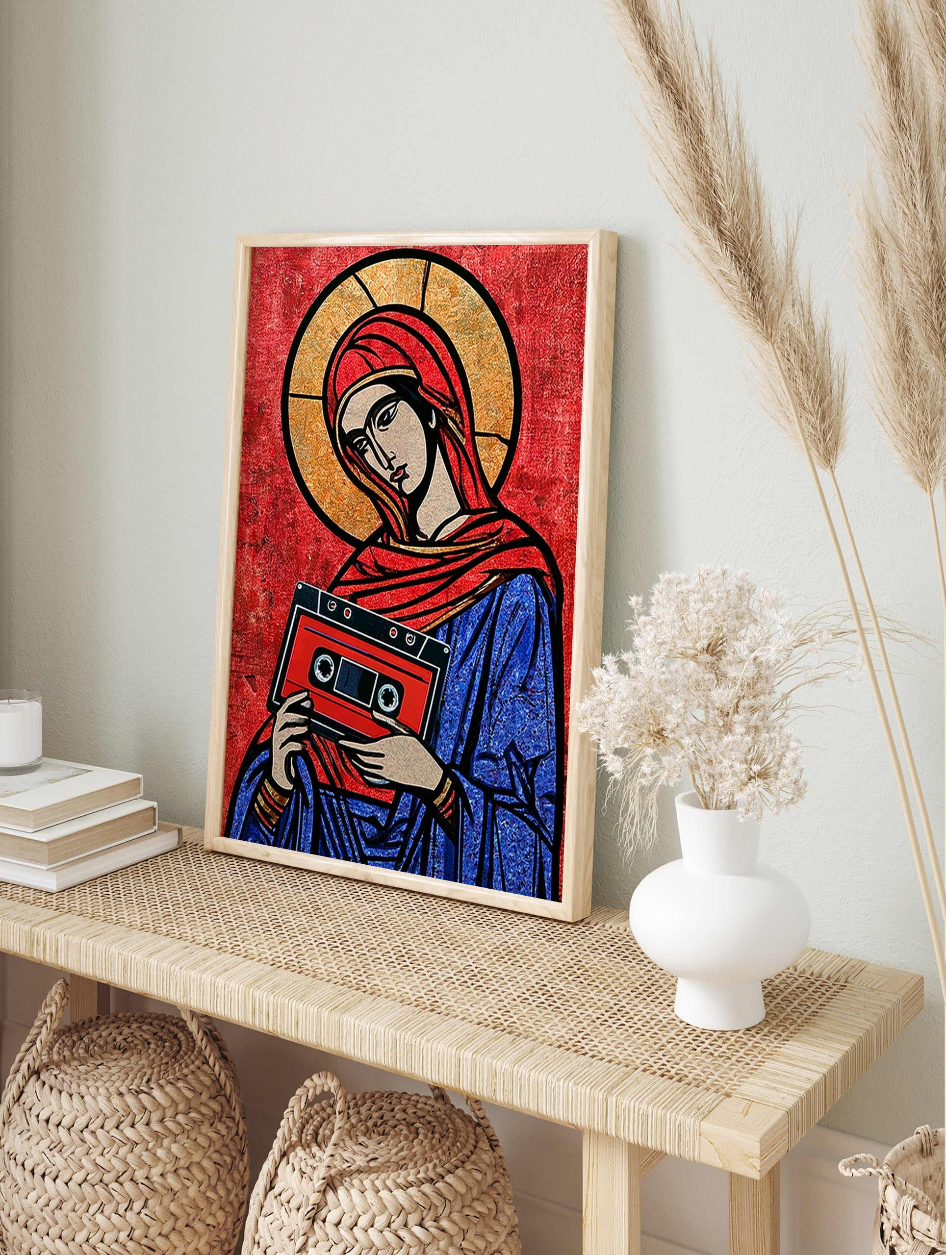 Stylised religious icon illustration holding a red cassette tape on a red background, graphic, in an alternate framed mockup