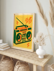 Retro boombox illustration with orange and green details on a yellow background, graphic, in an alternate framed mockup