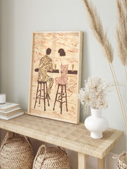 Retro illustrative art print of a couple with patterned clothes sitting at a bar with drinks, in an alternate framed mockup