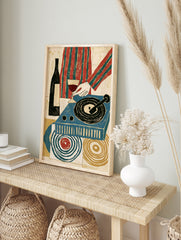 Retro illustrative print of a wine glass, bottle, and blue record player with abstract, in an alternate framed mockup