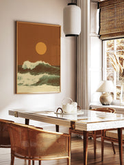 Retro ocean waves crashing with white foam under a large golden sun on an earthy orange background, in a styled room mockup