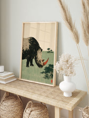 Stylized rhinoceros illustration with red horn and green field background art print, in an alternate framed mockup