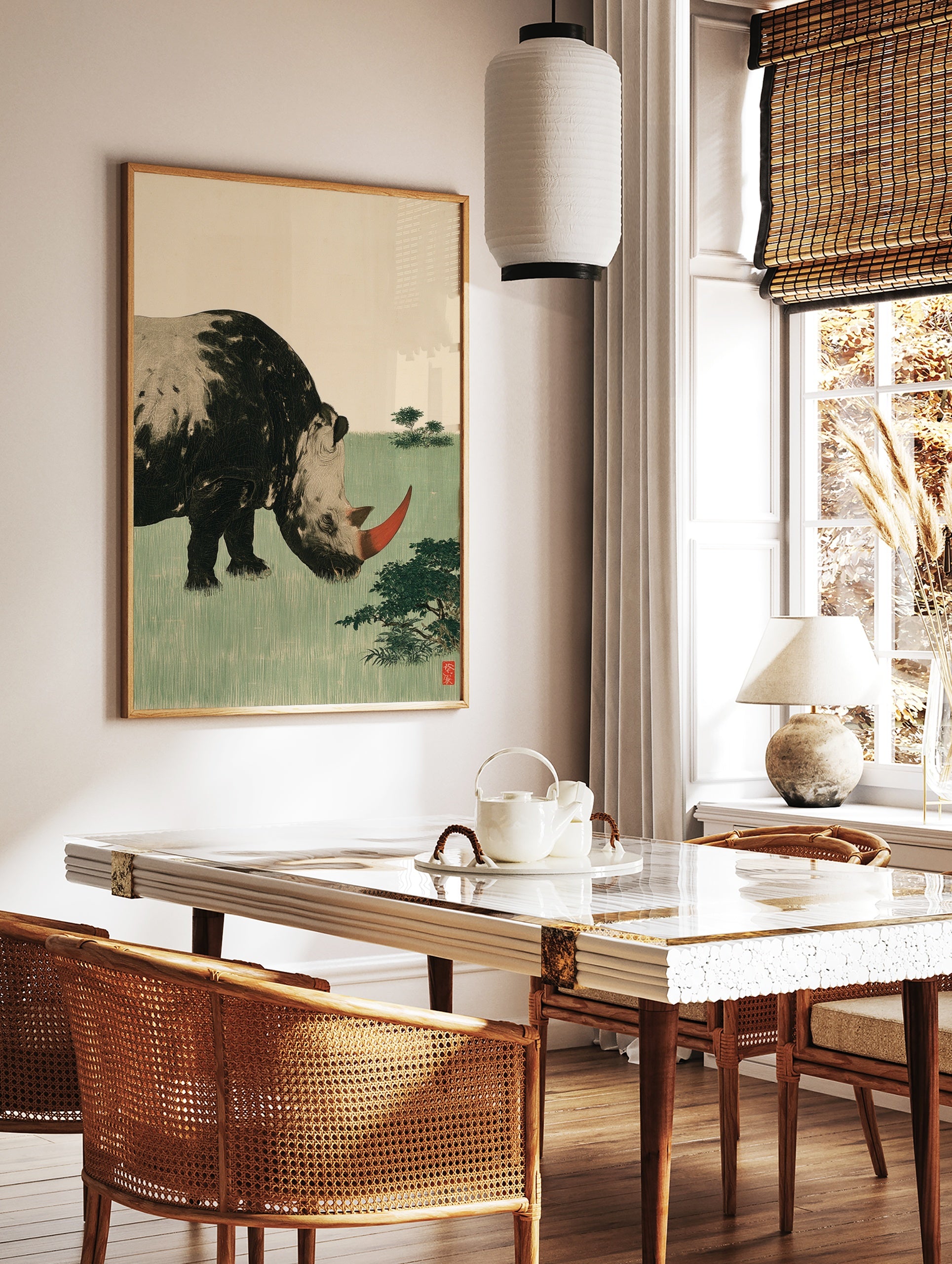 Stylized rhinoceros illustration with red horn and green field background art print, in a styled room mockup