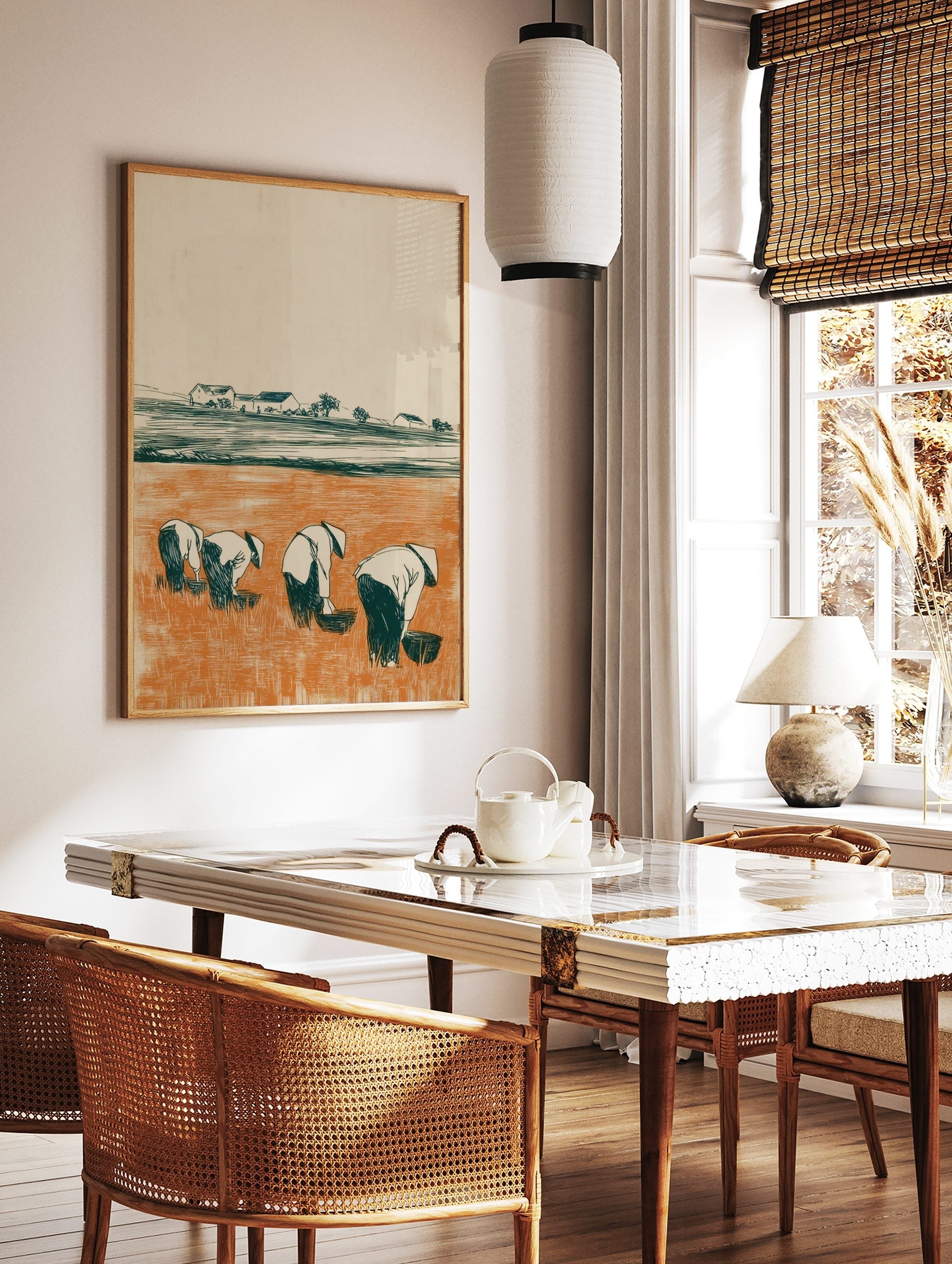 Illustrative print of four figures in conical hats working in an orange rice paddy field with, in a styled room mockup