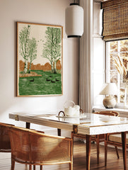 Woodcut style art print of birch trees and ducks swimming in a green river with brown foliage, in a styled room mockup