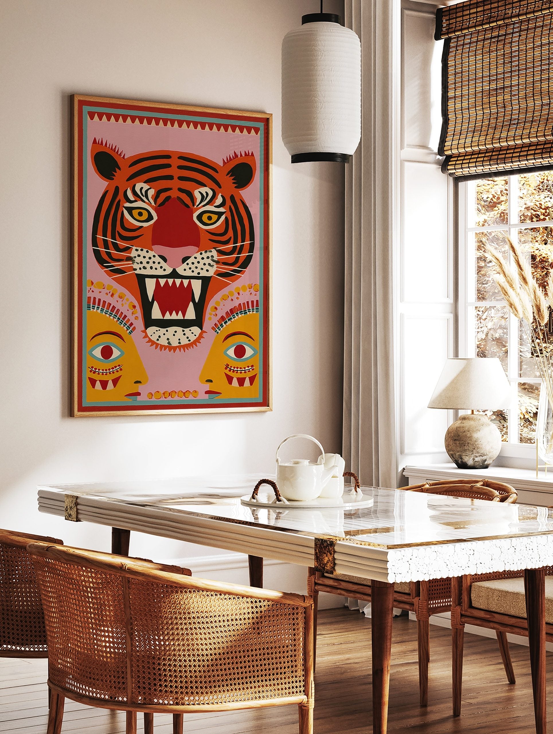 Stylised roaring tiger face with yellow eyes and two abstract human faces on a pink background, in a styled room mockup