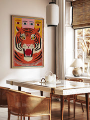 Roaring tiger head with black stripes and yellow eyes, human-like eyes above, framed by a, in a styled room mockup