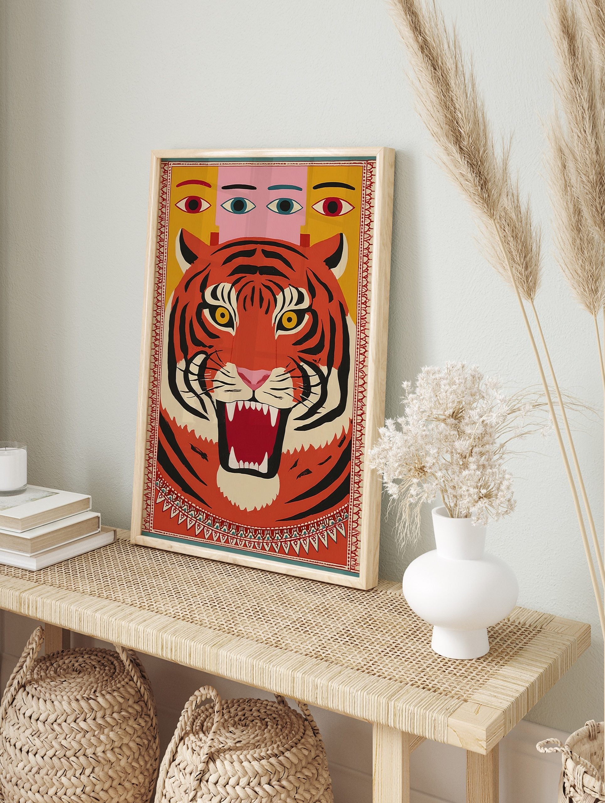 Bold illustrative roaring tiger wall art with multi-eyed figure on yellow background, framed, in an alternate framed mockup